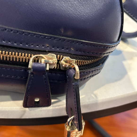 It’s a BCBG Maxazria bag with a lock.The color is bluish violet. - Picture 2 of 3